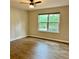 Bedroom features a bright window and wood-look flooring at 1003 River Plantation Dr, Woodstock, GA 30188