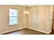Dining area with a large window and decorative light fixture at 1003 River Plantation Dr, Woodstock, GA 30188