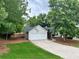 Well-kept home featuring a two-car garage, trimmed lawn, and paved driveway at 1003 River Plantation Dr, Woodstock, GA 30188