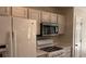 Well-equipped kitchen featuring modern appliances and bright white cabinets at 1003 River Plantation Dr, Woodstock, GA 30188