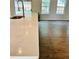 A kitchen countertop shines with a view of the wood-look floors and outdoor view at 1003 River Plantation Dr, Woodstock, GA 30188