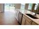 Stylish kitchen features stainless appliances, a dishwasher, and sliding glass door access at 1003 River Plantation Dr, Woodstock, GA 30188