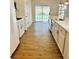 Bright kitchen with white appliances, light countertops, and access to the back patio at 1003 River Plantation Dr, Woodstock, GA 30188