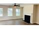 Spacious living room with a fireplace and ceiling fan at 1003 River Plantation Dr, Woodstock, GA 30188