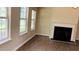 Bright living room with a fireplace and multiple windows at 1003 River Plantation Dr, Woodstock, GA 30188