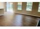 Living area featuring wood flooring and large windows at 1003 River Plantation Dr, Woodstock, GA 30188