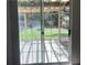 View of the backyard and patio, as seen through glass paneled sliding door at 1003 River Plantation Dr, Woodstock, GA 30188