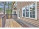 Spacious wood back deck offers outdoor living with a view of backyard trees at 1138 School Side Dr, Lithonia, GA 30058