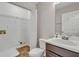 Small bathroom with single sink, white cabinets and vinyl floors at 1138 School Side Dr, Lithonia, GA 30058