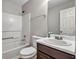 This bathroom has a combination tub and shower, as well as a dark vanity at 1138 School Side Dr, Lithonia, GA 30058