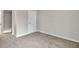 This carpeted bedroom features a closet with a white door and neutral walls at 1138 School Side Dr, Lithonia, GA 30058