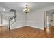 This dining room has hardwood floors, a chandelier, and entry to a carpeted living room at 1138 School Side Dr, Lithonia, GA 30058