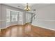 This dining room features hardwood floors, large bay windows, and a chandelier at 1138 School Side Dr, Lithonia, GA 30058