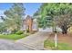 Attractive two-story brick home with lush landscaping, bay windows, and a convenient two-car garage at 1138 School Side Dr, Lithonia, GA 30058