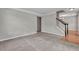 Cozy living room with carpet, staircase and hardwood floors in foyer at 1138 School Side Dr, Lithonia, GA 30058