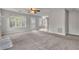 Expansive living room featuring new carpet, ceiling fan, and natural light at 1138 School Side Dr, Lithonia, GA 30058