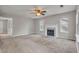Living room featuring plush carpeting, a fireplace, and natural light at 1138 School Side Dr, Lithonia, GA 30058