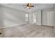 Cozy main bedroom with a ceiling fan, plush carpet, and neutral paint, leading to a walk-in closet at 1138 School Side Dr, Lithonia, GA 30058