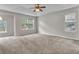 Spacious main bedroom with trey ceilings, carpet floors, and ample natural light from the large windows at 1138 School Side Dr, Lithonia, GA 30058