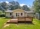 Backyard featuring a wood deck, lush green grass, and a shed at 3274 Ridgecrest Se Rd, Smyrna, GA 30080