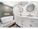 Modern bathroom featuring double vanities, standalone tub and glass shower at 3274 Ridgecrest Se Rd, Smyrna, GA 30080