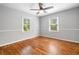 Bright bedroom featuring hardwood floors, neutral walls, and two windows for natural light at 3274 Ridgecrest Se Rd, Smyrna, GA 30080