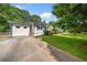View of the side of the home showing the driveway, additional building and yard at 3274 Ridgecrest Se Rd, Smyrna, GA 30080