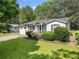 Charming single-story home features a well-manicured lawn and cozy front porch at 3274 Ridgecrest Se Rd, Smyrna, GA 30080
