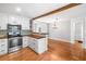 Bright kitchen with white cabinets, stainless appliances, and an open view to the dining room at 3274 Ridgecrest Se Rd, Smyrna, GA 30080