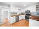 Modern kitchen featuring white cabinets, stainless steel appliances, and wood countertops at 3274 Ridgecrest Se Rd, Smyrna, GA 30080