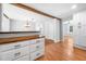 Bright kitchen with wooden breakfast bar, white cabinets, and hardwood flooring at 3274 Ridgecrest Se Rd, Smyrna, GA 30080
