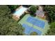 Aerial view of community pool, tennis courts and clubhouse in a wooded setting at 3290 Cherry Oak Ln, Cumming, GA 30041
