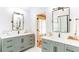 Bathroom featuring double sink vanity, gray cabinets, framed mirrors, and tiled floors at 3290 Cherry Oak Ln, Cumming, GA 30041