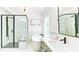 Bright bathroom featuring a large tub, a shower, and a dark framed mirror at 3290 Cherry Oak Ln, Cumming, GA 30041