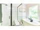 Bathroom featuring a walk-in glass shower, free-standing tub, and natural light at 3290 Cherry Oak Ln, Cumming, GA 30041