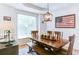 Inviting dining room with a wooden table and chairs, complemented by an elegant light fixture at 3290 Cherry Oak Ln, Cumming, GA 30041