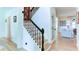 Bright foyer with staircase featuring decorative iron railings and hardwood floors leading into a cozy living area at 3290 Cherry Oak Ln, Cumming, GA 30041