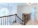 Hallway with hardwood floors, iron railings, and natural light from a palladian window at 3290 Cherry Oak Ln, Cumming, GA 30041