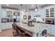 Bright eat-in kitchen with a center island, seating, white cabinetry, and stainless appliances at 3290 Cherry Oak Ln, Cumming, GA 30041