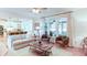 Sunlit living room featuring a comfortable seating arrangement and a view of the outdoor patio at 3290 Cherry Oak Ln, Cumming, GA 30041