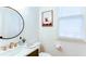 Chic powder room featuring a marble countertop, modern fixtures, and a decorative mirror at 3290 Cherry Oak Ln, Cumming, GA 30041