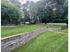 Expansive backyard featuring a play set, white picket fence, and well-manicured lawn at 3532 W Hampton Nw Dr, Marietta, GA 30064