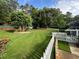 Spacious backyard with lush green grass, privacy fence, and play structure at 3532 W Hampton Nw Dr, Marietta, GA 30064