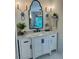 Stylish bathroom featuring a white vanity with marble countertop and decorative sconces at 3532 W Hampton Nw Dr, Marietta, GA 30064