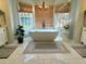 Beautiful bathroom featuring a freestanding tub, chandelier, and natural light from the large windows at 3532 W Hampton Nw Dr, Marietta, GA 30064
