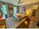 Inviting bedroom with a colorful bed, patterned rug, and ample natural light at 3532 W Hampton Nw Dr, Marietta, GA 30064