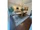 Elegant dining room with a hardwood floor, stylish rug, and a wooden table set for dining at 3532 W Hampton Nw Dr, Marietta, GA 30064