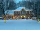 Charming two-story home adorned with festive lights and snow-covered landscape at 3532 W Hampton Nw Dr, Marietta, GA 30064