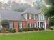 Beautiful brick home with a well-maintained lawn, complemented by lush landscaping at 3532 W Hampton Nw Dr, Marietta, GA 30064