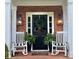 Welcoming front porch with rocking chairs, plants, and stylish lighting fixtures at 3532 W Hampton Nw Dr, Marietta, GA 30064